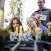 Ann Arbor residents Grace Heard, 6, and Emma Herrick, 5, (left to right) inspect flowers during Earth Day on Sunday, April 21. AnnArbor.com I Daniel Brenner